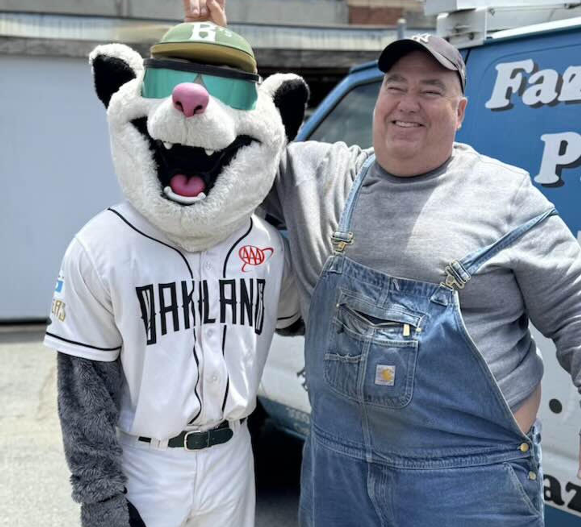 Tony Fazule, owner of Fazule & Sons Plumbing, standing in front of his branded service van in Oakland